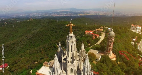 Aerial footage around the Expiatory Church of the Sacred Heart of Jesus (Temple Expiatori del Sagrat Cor) in Tibidabo mountain in Barcelona, Catalonia, Spain.  photo