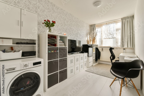 a laundry room with washer  dryer and washing machine on the floor in front of the window there is a wallpaper