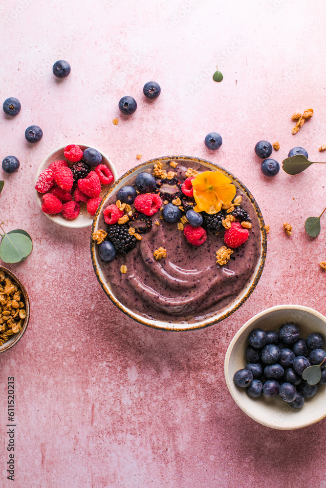 Blueberry Smoothie Bowl with Granola, Banana, and Chia Seeds, Healthy Food, Vegan or Vegetarian Diet Food Concept, Bright Background Blueberry Smoothie Bowl with Granola, Banana, and Chia Seeds, Healthy Food, Vegan or Vegetarian Diet Food Concept, Bright Background