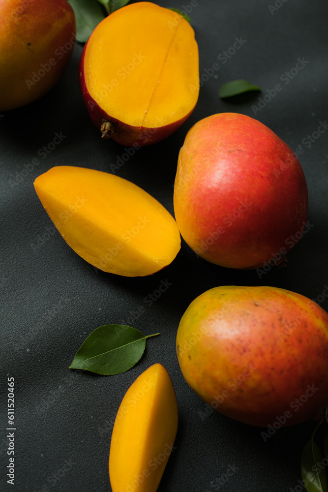 Mango background design concept. Top view of  fresh mango fruit pattern with leaves on  table.