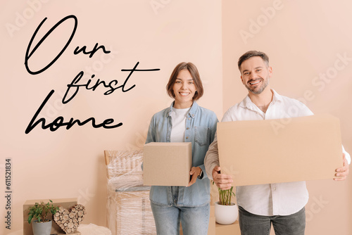 First-time buyer. Happy couple with moving boxes in their new apartment and phrase Our First Home