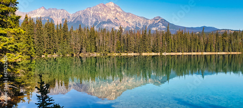 Panoramic view of Pyramid Mountain reflected in the Pyramid Lake near Jasper in the Canada Rockies