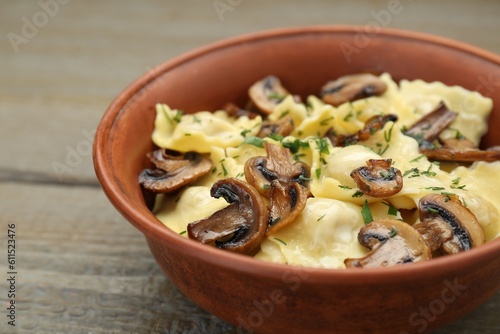 Delicious ravioli with mushrooms on wooden table, closeup
