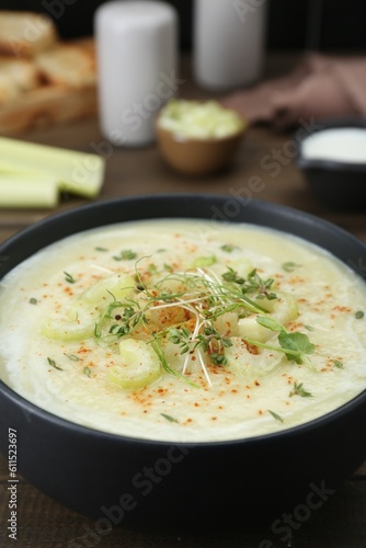 Bowl of delicious celery soup on table, closeup