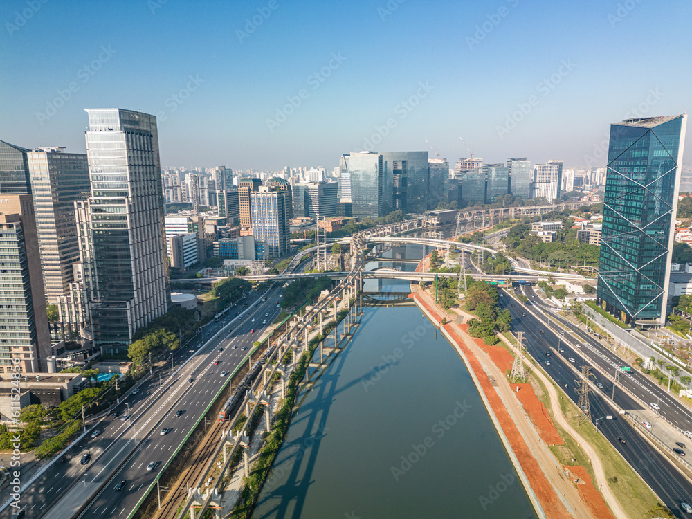 2023 view of the Pinheiros river with modern buildings beside it and the famous Octavio Frias de Oliveira bridge in the city of São Paulo.