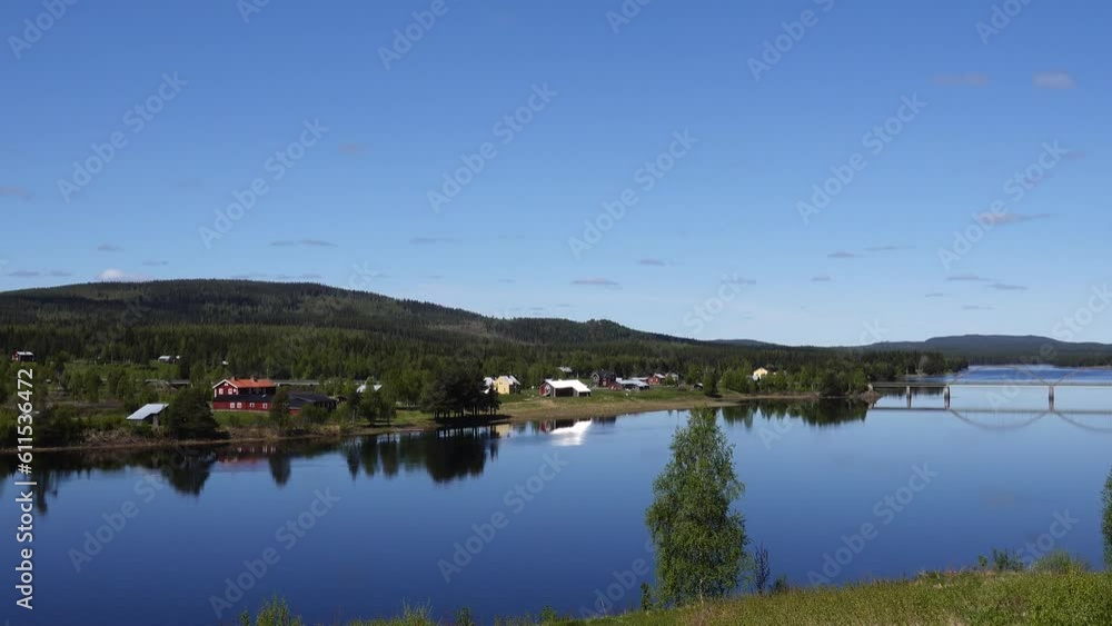 Vindeln, Sweden A summer landscape and steel car bridge crossing the Pitea River on a sunny day. Vindeln, Sweden A summer landscape and steel car bridge crossing the Pitea River on a sunny day.