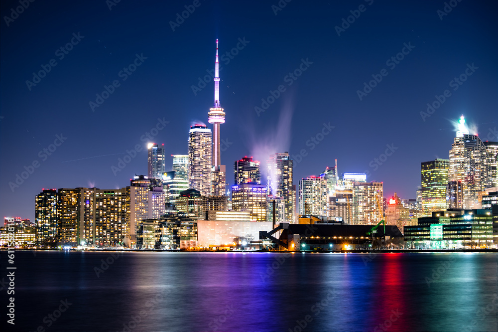 A full moon rising over Toronto Canada. Beautiful long exposure colourful night scene reflection in water