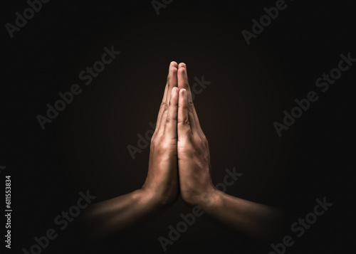 Praying hands with faith in religion and belief in God on dark background Fototapet