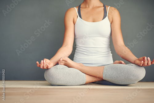 Woman, hands and yoga meditation on floor in spiritual wellness, zen or healthy workout at home. Relax and calm female person or yogi meditating for mindful exercise or awareness on wall mockup space