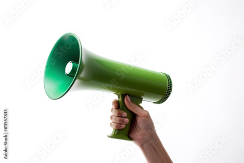 The hand holds a green megaphone on a white background. Announcement concept. Shout It Out © dewaai
