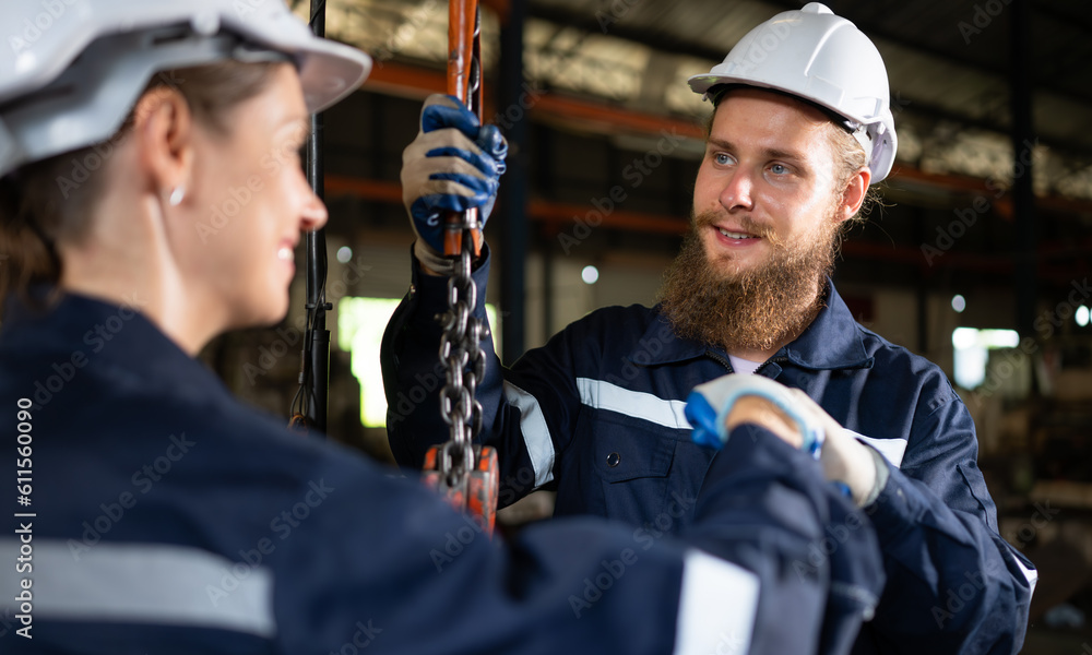 Two technicians inspecting and testing the operation of lifting cranes in heavy industrial plants. Two technicians inspecting and testing the operation of lifting cranes in heavy industrial plants.