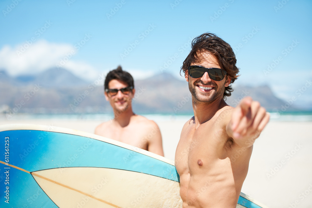Obraz premium Beach, pointing and man surfing friends outdoor together for summer vacation or holiday trip overseas. Surf, sea or travel with a young male surfer in sunglasses and friend bonding on an ocean coast