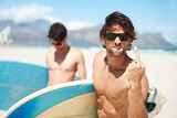 Beach, middle finger and man surfing friends outdoor together for summer vacation or holiday trip overseas. Surf, sea or rude with a young male surfer in sunglasses and friend bonding at the coast