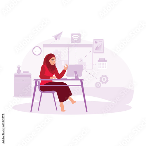 Muslim businesswoman, wearing hijab, working professionally in the office with a computer. Trend modern vector flat illustration.