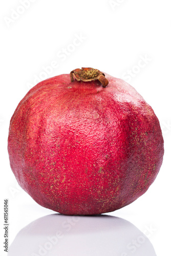 Whole pomegranate over white background