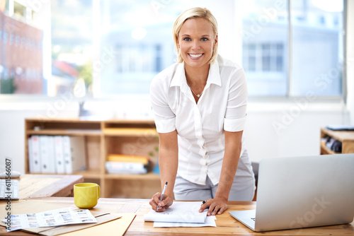 Happy, smile and portrait of a businesswoman in her office writing on paper for startup planning. Confidence, success and professional female hr manager working on a company report in the workplace.
