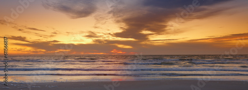 Sky, sunset and sea at morning on the horizon with ocean and waves landscape. Sunrise, calm weather and summer by the beach with coastline and outdoor with the sun setting by water in nature