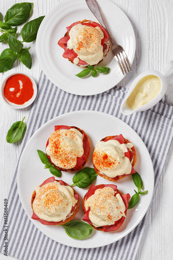 Eggs Benedict on white plate, top view Eggs Benedict on white plate, top view