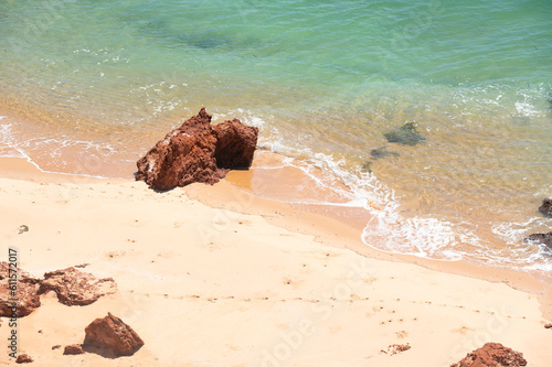 Rocks in the Ocean sandy beach and turquoise water. Top View