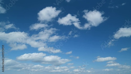 Blue sky background with tiny stratocumulus and cumulus fluffy clouds. Concepts of weather forecast, vacations. Timelapse. photo