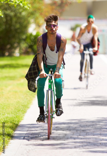 Bicycle, portrait and man or friends in city streetwear for college, university or outdoor travel in carbon footprint. Youth cycling or people in gen z fashion, bike for transport and park or campus