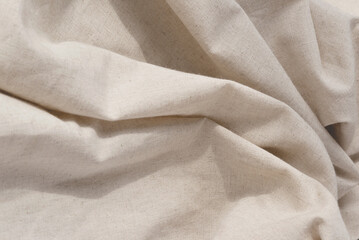 Soft draped neutral beige linen fabric texture, aesthetic textile background with abstract folds, wedding or brand template, copy space