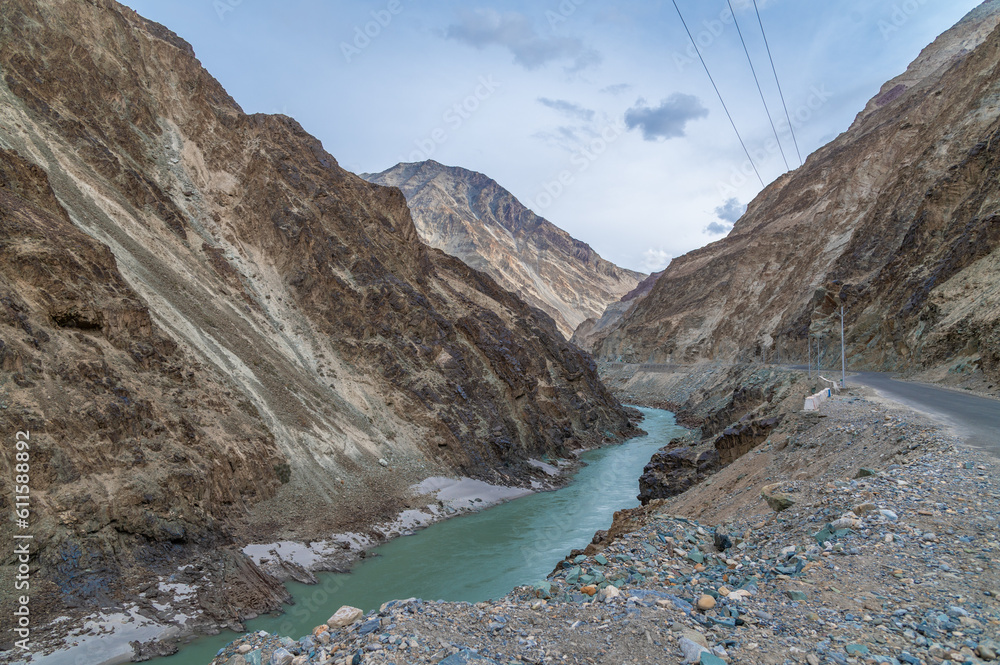Zanskar mountain river valley Ladakh India with scenic landscape. Green color Zanskar river between two mountain Peaks, Valley view in Ladakh. view of River on the Roadside with dramatic clouds.
