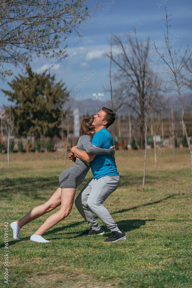 Fit male person saved his female partner from falling Fit male person saved his female partner from falling