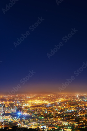 Fototapeta Naklejka Na Ścianę i Meble -  Night, sky and city with lights, buildings and Cape Town with view, traffic and urban development. Future, cloud and industry with growth, transportation and landscape with streets, dark and travel