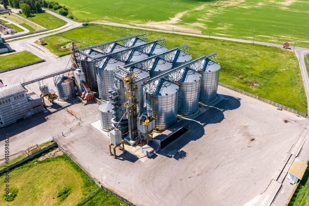 aerial panoramic view on agro-industrial complex with silos and grain drying line for drying cleaning and storage of cereal crops aerial panoramic view on agro-industrial complex with silos and grain drying line for drying cleaning and storage of cereal crops