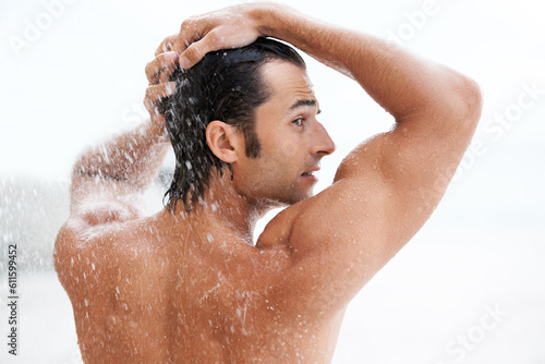 Clean, back view of a man in the shower and health wellness indoors. Cleaning in bathroom, muscular or wellbeing and rearview of wet male person showering for refreshing hygiene protection or washing