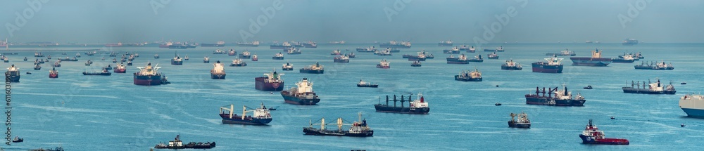 Wide panorama image of Container Ships anchored at the Singapore strait.