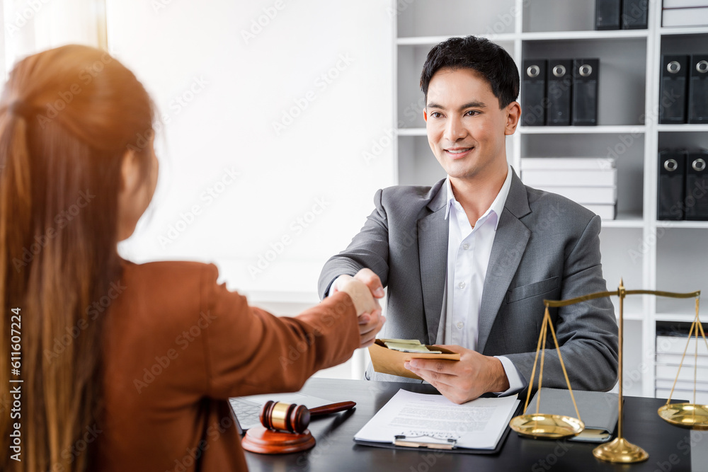 Lawyer shaking hands with client after discussing final contract agreement Lawyer shaking hands with client after discussing final contract agreement