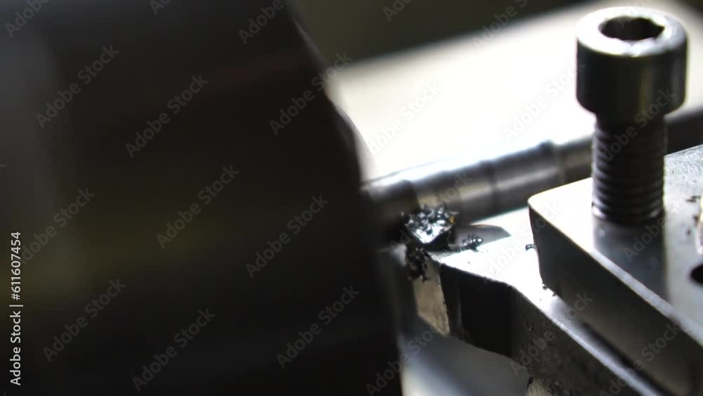 Close-up lathe machine operation by cutting the metal tube. vintage lathe machine tool operates with metal detail under mature worker control in old production plant workshop. Slow motion Close-up lathe machine operation by cutting the metal tube. vintage lathe machine tool operates with metal detail under mature worker control in old production plant workshop. Slow motion