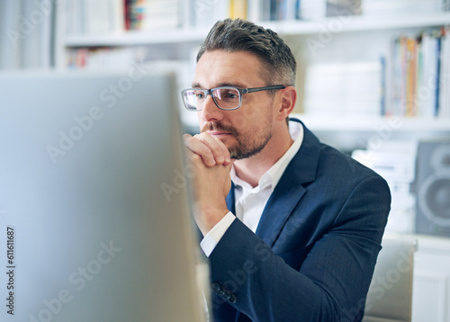 Ceo, employee and man with focus, reading email and consultant in a workplace, research and search internet. Male person, entrepreneur or mature agent with a pc, concentration and website information