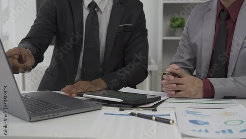 Asian businessman sharing ideas and planning business analysis with team at meeting in business office with people sharing documents with pie charts and statistics 4k 