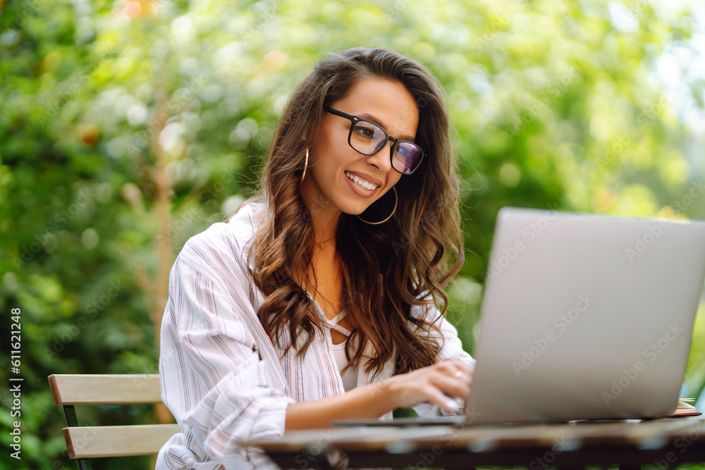 Young woman sitting on cafe with laptop. Concept for education, business, blog or freelance. Young woman sitting on cafe with laptop. Concept for education, business, blog or freelance.