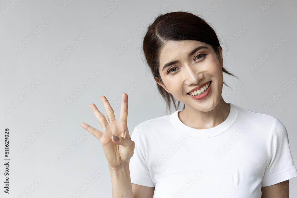 asian woman pointing up four fingers, 4 points gesture asian woman pointing up four fingers, 4 points gesture