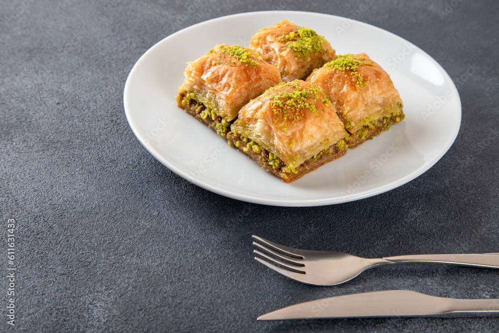 Pistachio Turkish baklava on a white plate.Traditional delicious Turkish baklava