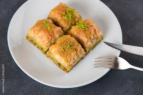 Pistachio Turkish baklava on a white plate.Traditional delicious Turkish baklava 