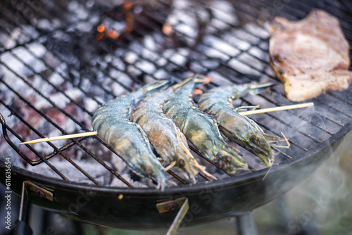 King prawns on barbecue grill. Cooking raw large shrimp.