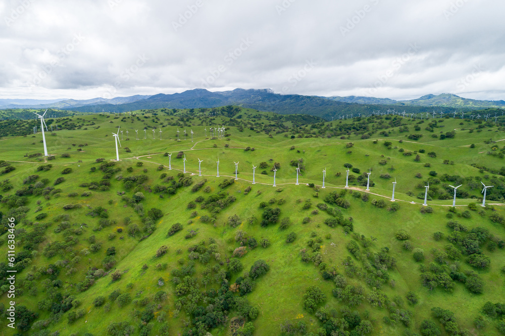 Windmills in Upper Cottonwood Creek Wildlife Area near Los Banos. California. USA. Mountains in Background. Drone