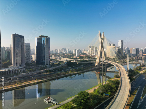 2023 view of the Pinheiros river with modern buildings beside it and the famous Octavio Frias de Oliveira bridge in the city of S  o Paulo.