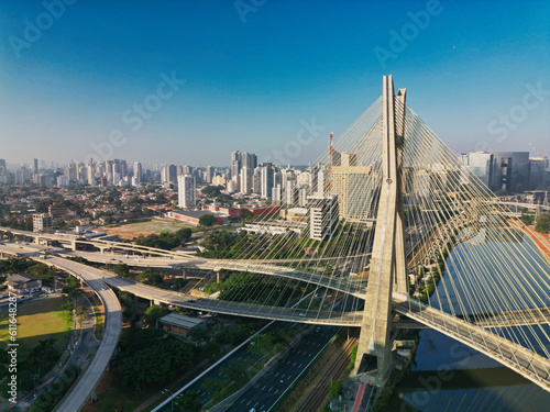 2023 view of the Pinheiros river with modern buildings beside it and the famous Octavio Frias de Oliveira bridge in the city of São Paulo.