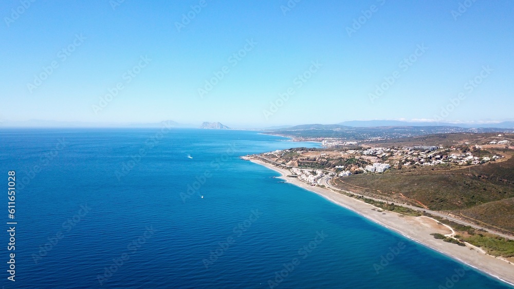 aerial view towards the beach near Manilva with a view towards Torreguadiaro, Sotogrande and the Rock of Gibraltar and Africa at the horizon, Mediterranean Sea, Andalusia, Malaga, Spain