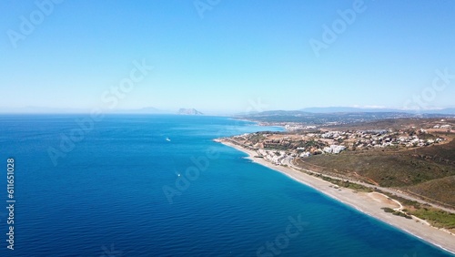 aerial view towards the beach near Manilva with a view towards Torreguadiaro, Sotogrande and the Rock of Gibraltar and Africa at the horizon, Mediterranean Sea, Andalusia, Malaga, Spain