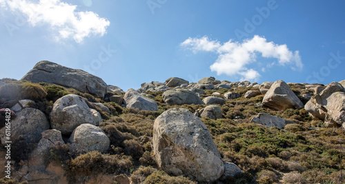 Huge granite rock that surrounds Volax village in Tinos island Cyclades Greece. Summer day blue sky
