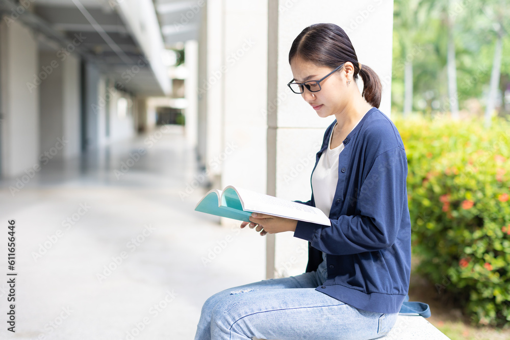Smart woman sitting reading a book use free time for learning education bookworm nerd in university. Smart woman sitting reading a book use free time for learning education bookworm nerd in university.