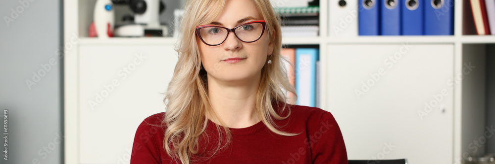Portrait of businesswoman in glasses at workplace in office. Secretary manager and business assistant concept Portrait of businesswoman in glasses at workplace in office. Secretary manager and business assistant concept