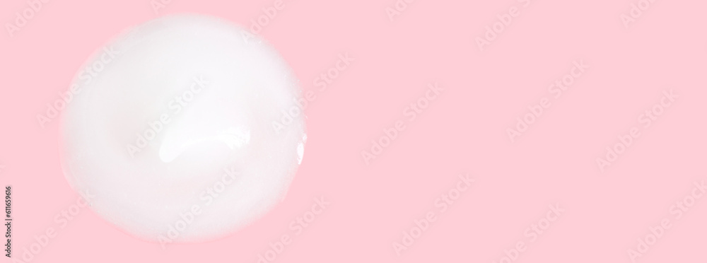 A smear of greasy melting cream. On a pink background. A smear of greasy melting cream. On a pink background.